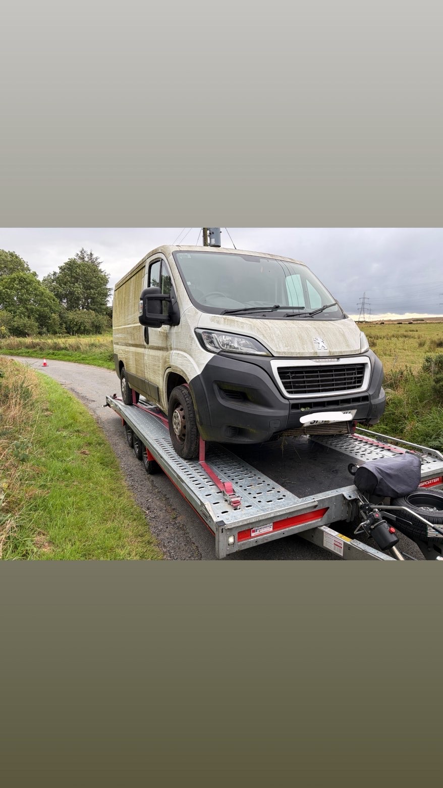 White Peugeot van recovered and secured on flatbed transporter